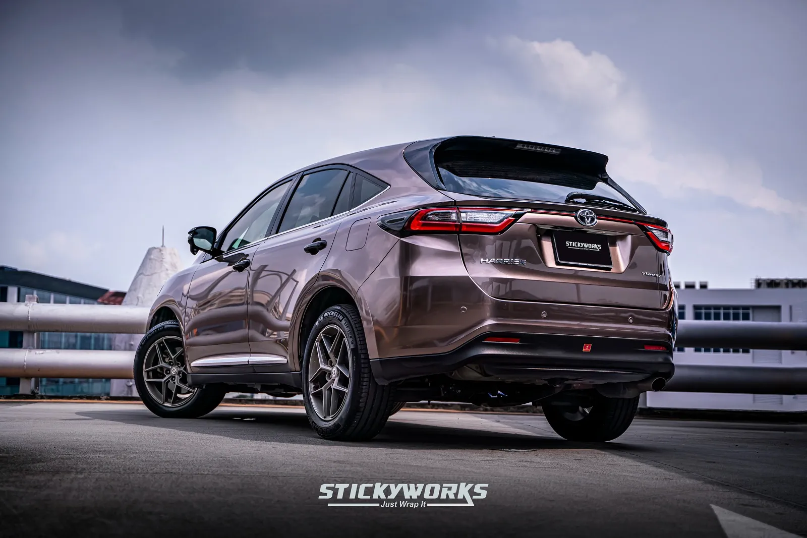 Rear angled view of a brown SUV featuring a car wrap