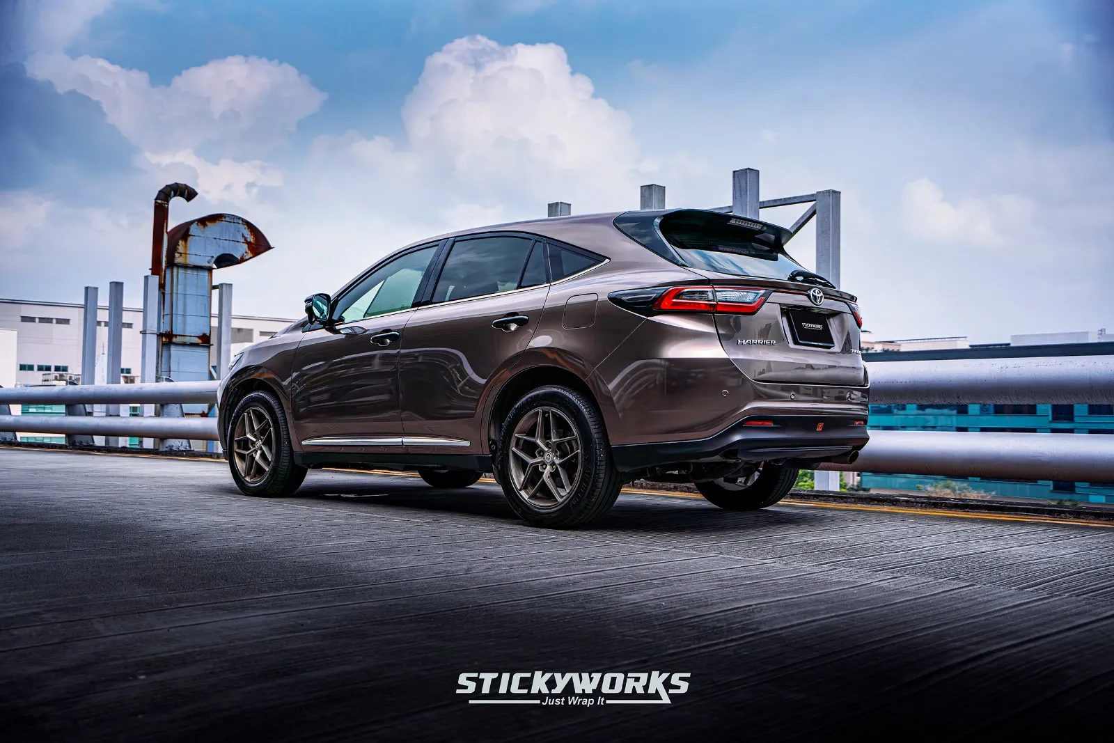 Rear three-quarter view of a brown SUV displaying a car wrap