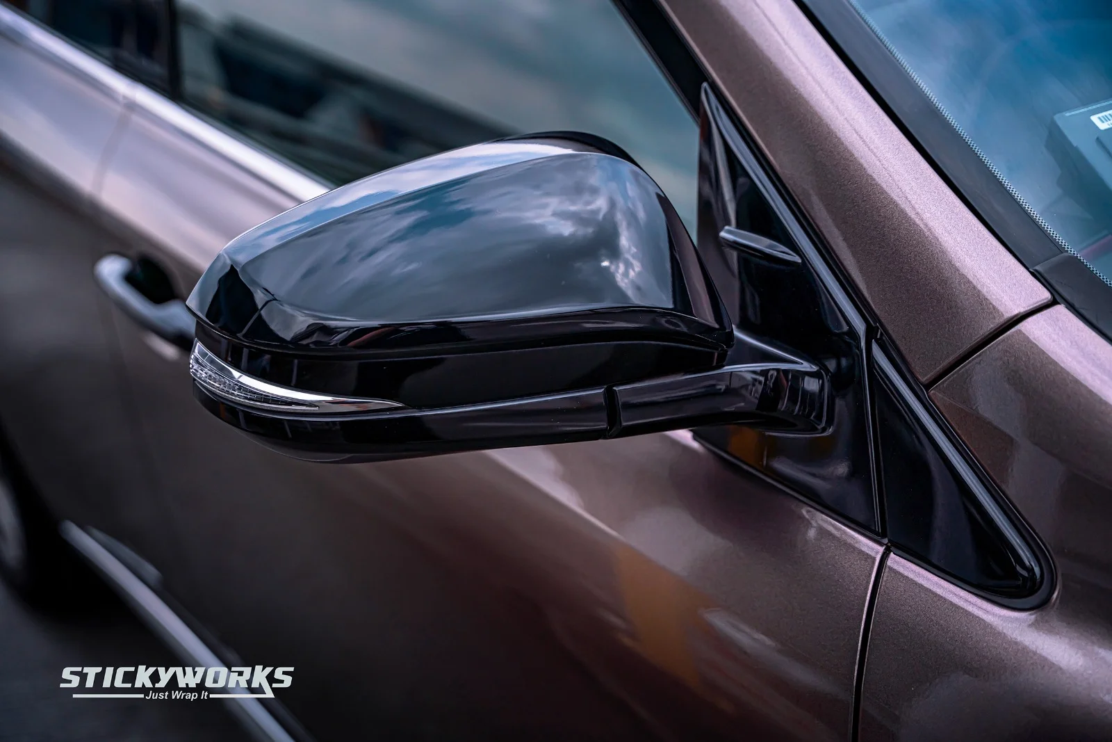 StickyWorks car wrap side mirror close-up showing glossy finish and precision installation