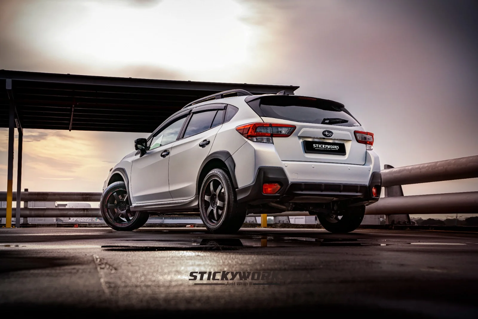 StickyWorks Subaru car wrap rear view under sunset lighting highlighting smooth finish