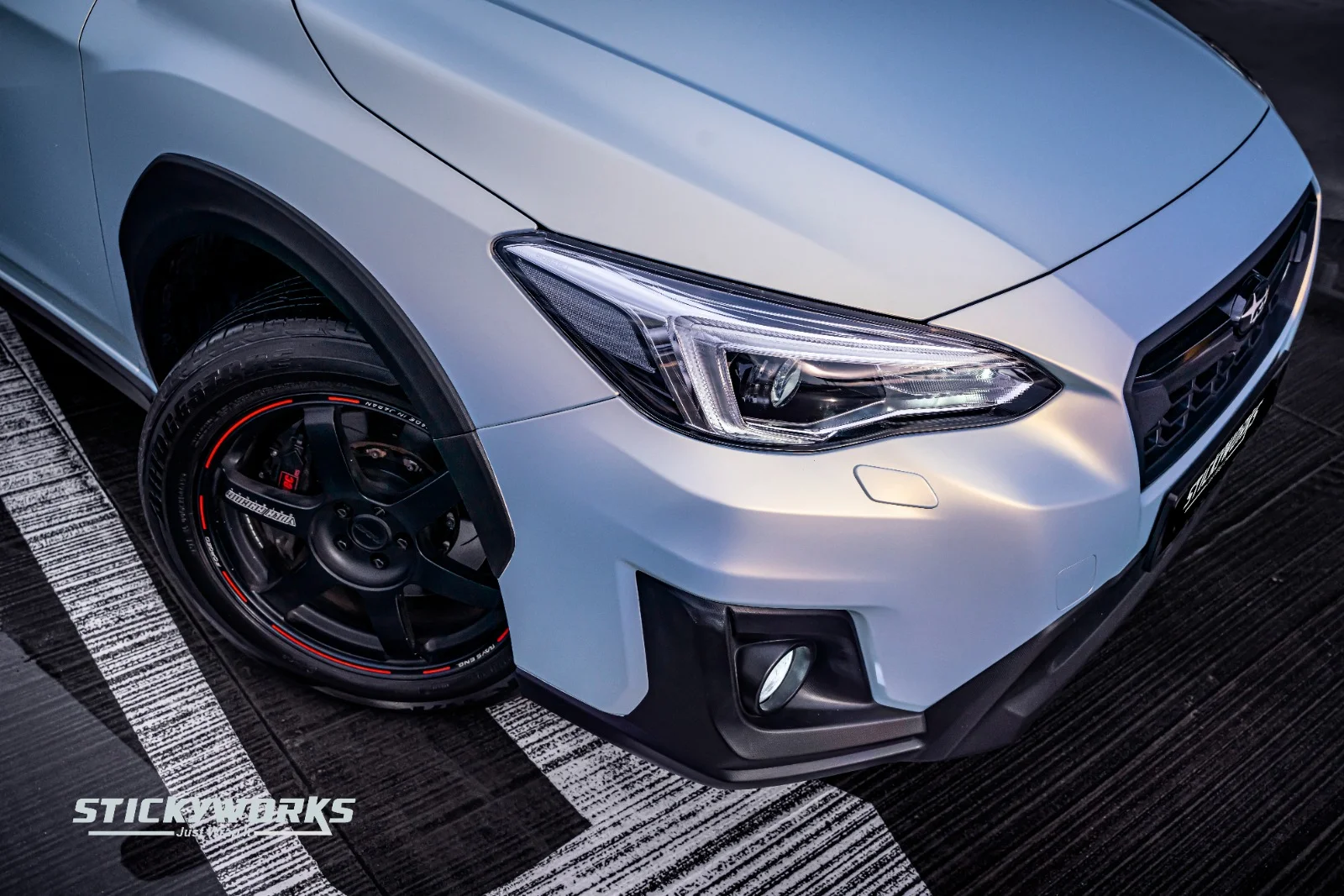 StickyWorks car wrap wheel detail with black rims showcasing styling and finish