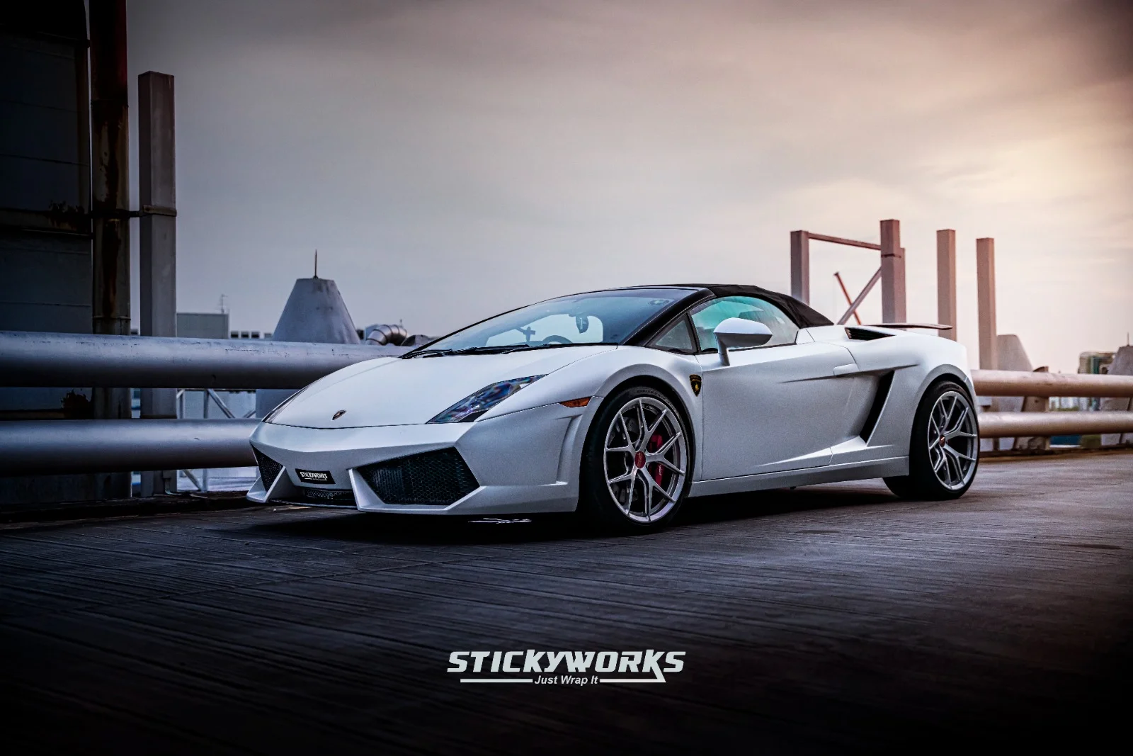 StickyWorks Lamborghini front angle in matte white wrap during sunset highlighting contours and premium finish