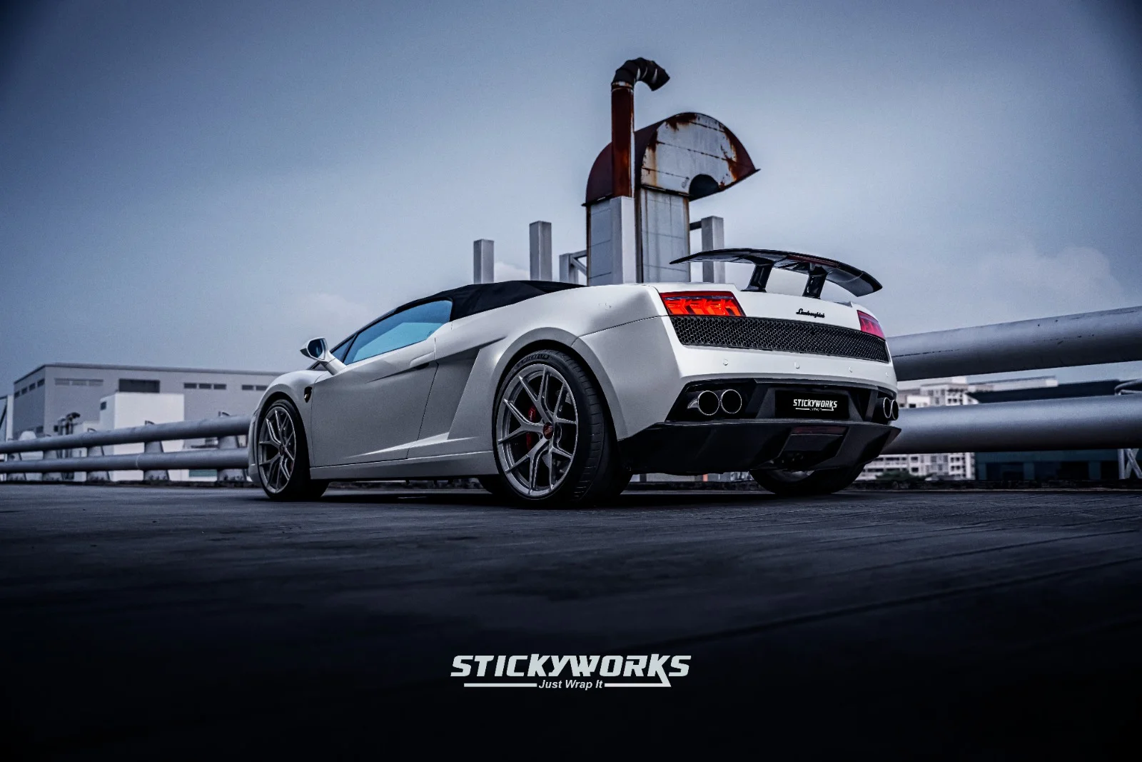 StickyWorks Lamborghini rear angle in matte white wrap showing aggressive styling and clean wrap installation