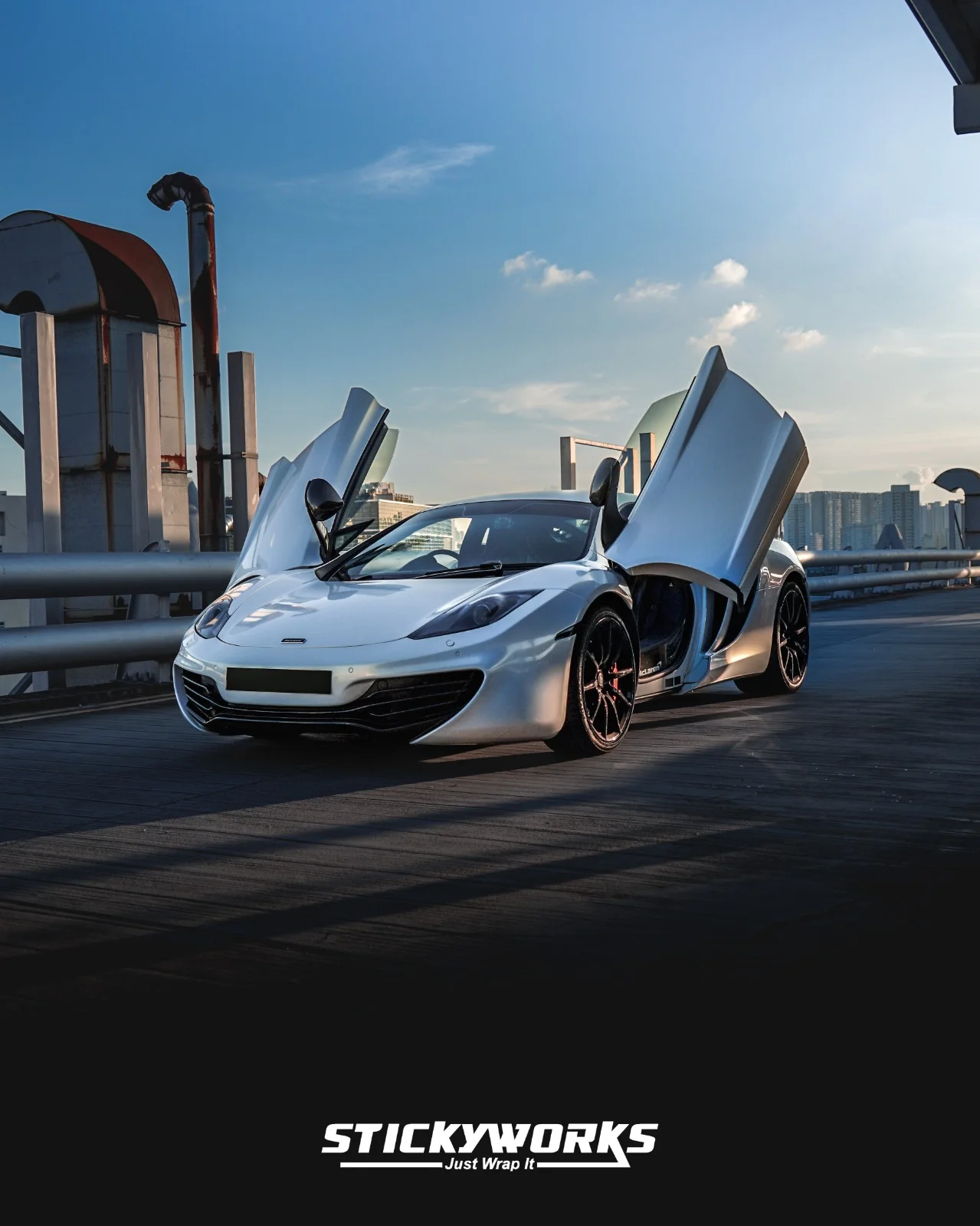StickyWorks McLaren with doors open in gloss white wrap highlighting premium finish and attention to detail
