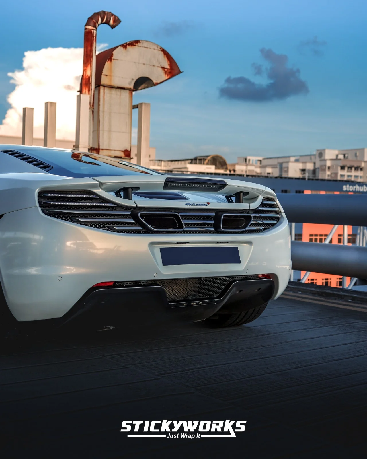 StickyWorks McLaren rear detail showing exhaust, spoiler and gloss white wrap with clean professional finish