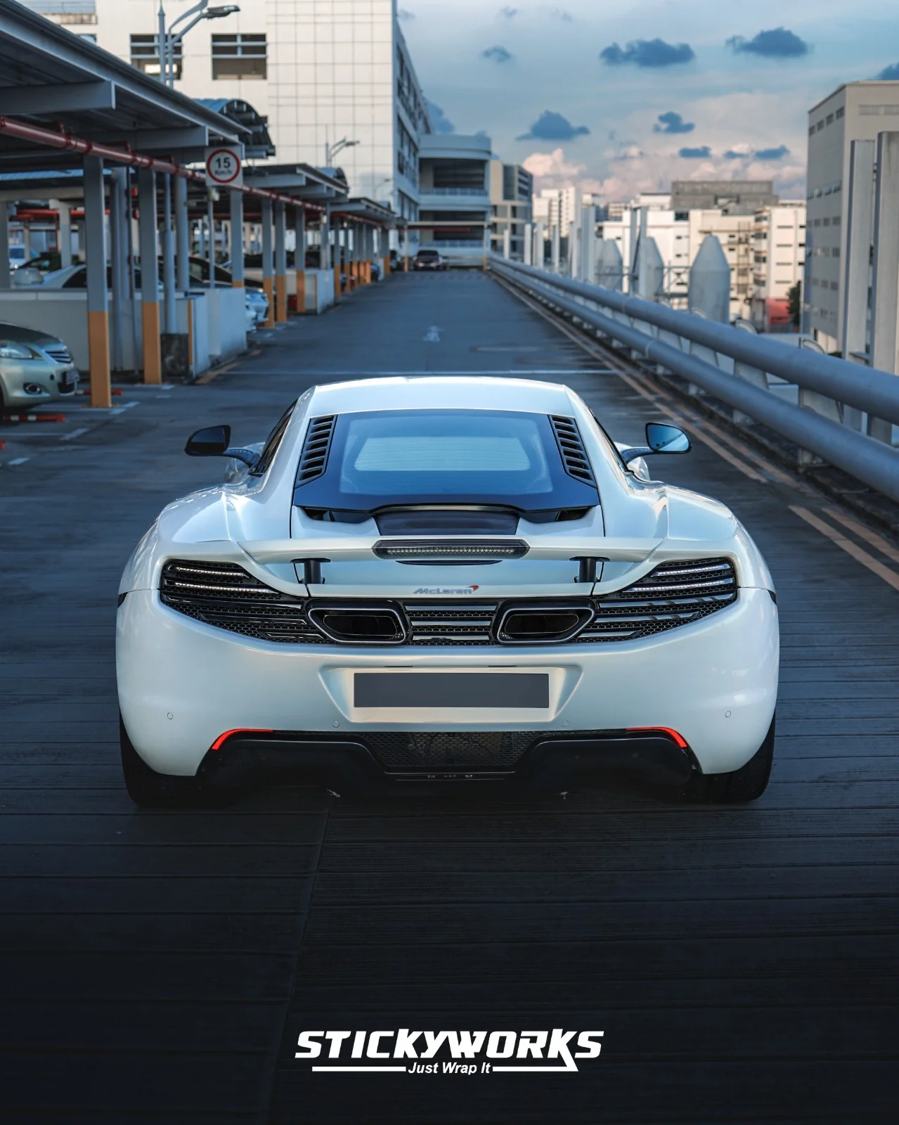 StickyWorks McLaren rear symmetry shot in gloss white wrap showcasing balanced design and flawless wrap