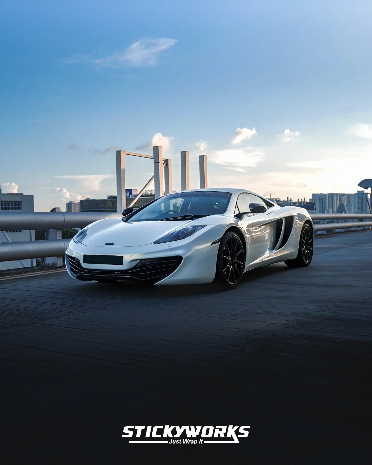 StickyWorks McLaren side angle in gloss white wrap showcasing full body coverage and seamless installation