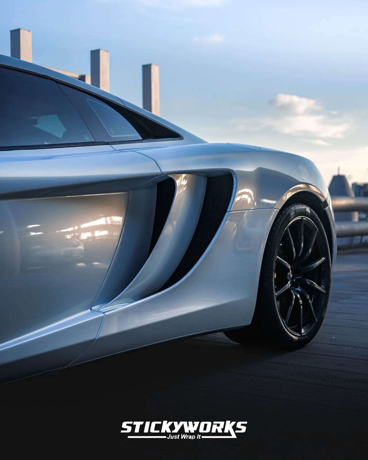 StickyWorks McLaren side intake detail showing precision wrap application and clean panel alignment