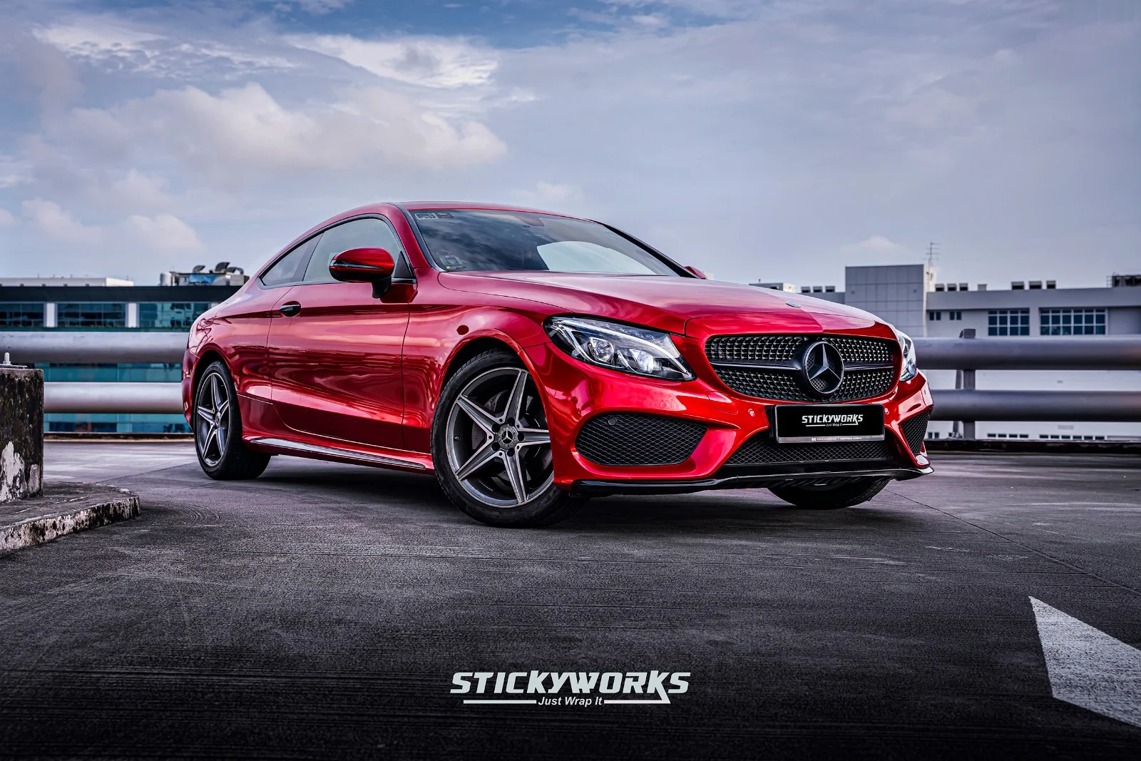 StickyWorks Mercedes coupe front angle in gloss red wrap emphasizing premium installation and sharp styling
