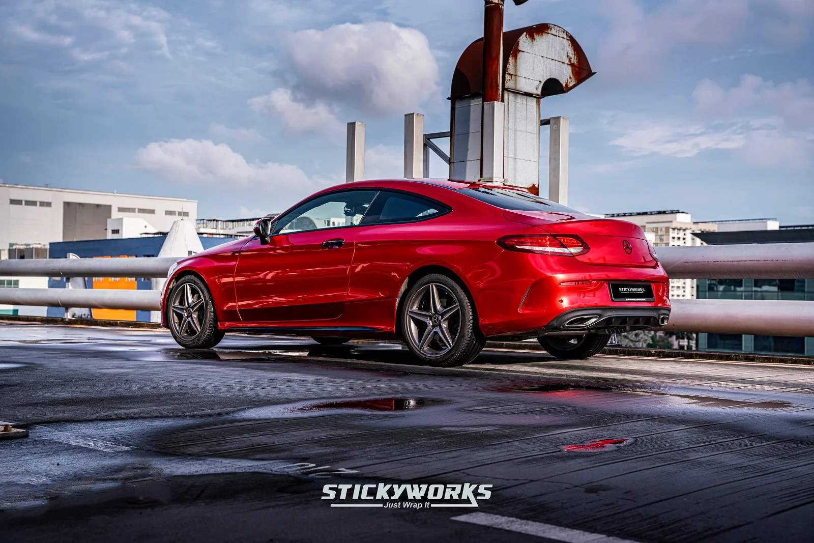 StickyWorks Mercedes coupe rear wide shot in gloss red wrap showing full body coverage and consistent finish