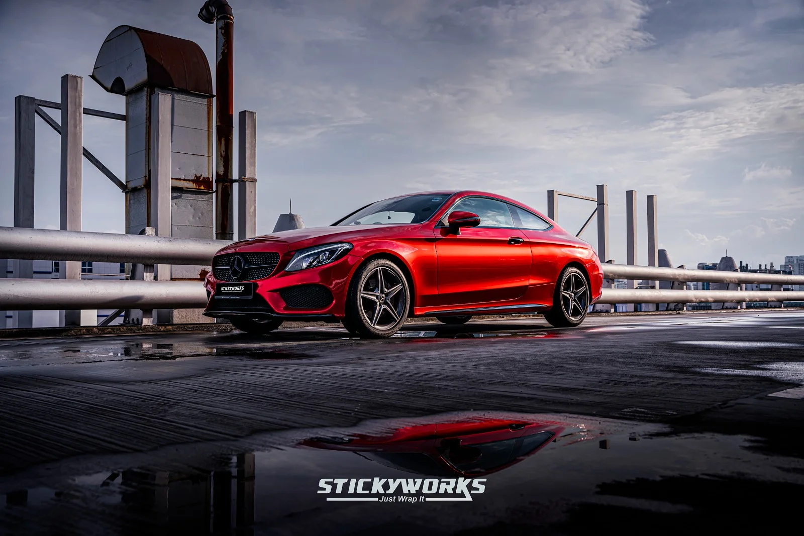 StickyWorks Mercedes coupe in gloss red wrap with reflection shot showcasing premium vinyl quality