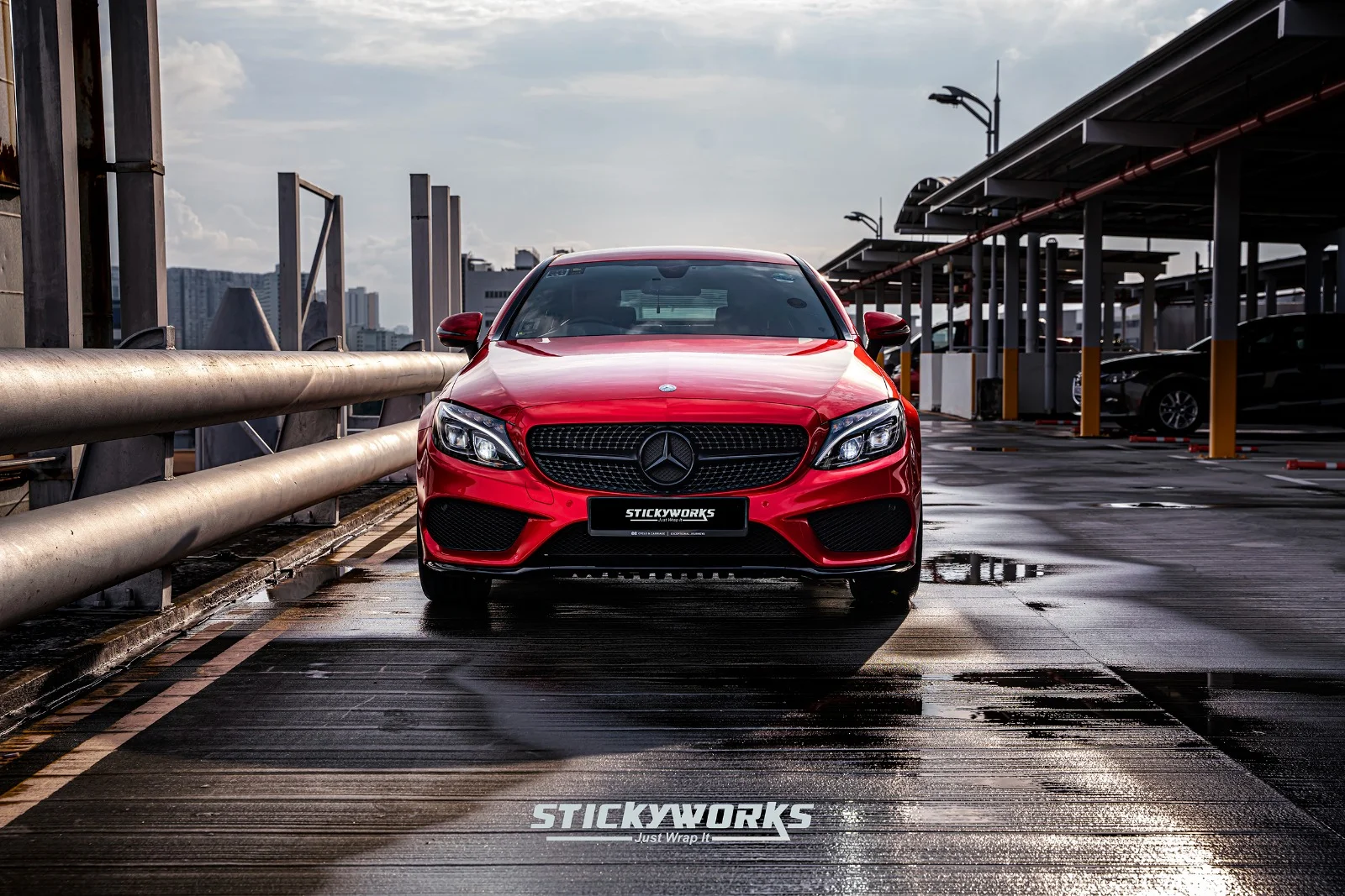 StickyWorks Mercedes front symmetry shot in gloss red wrap highlighting balanced design and professional installation