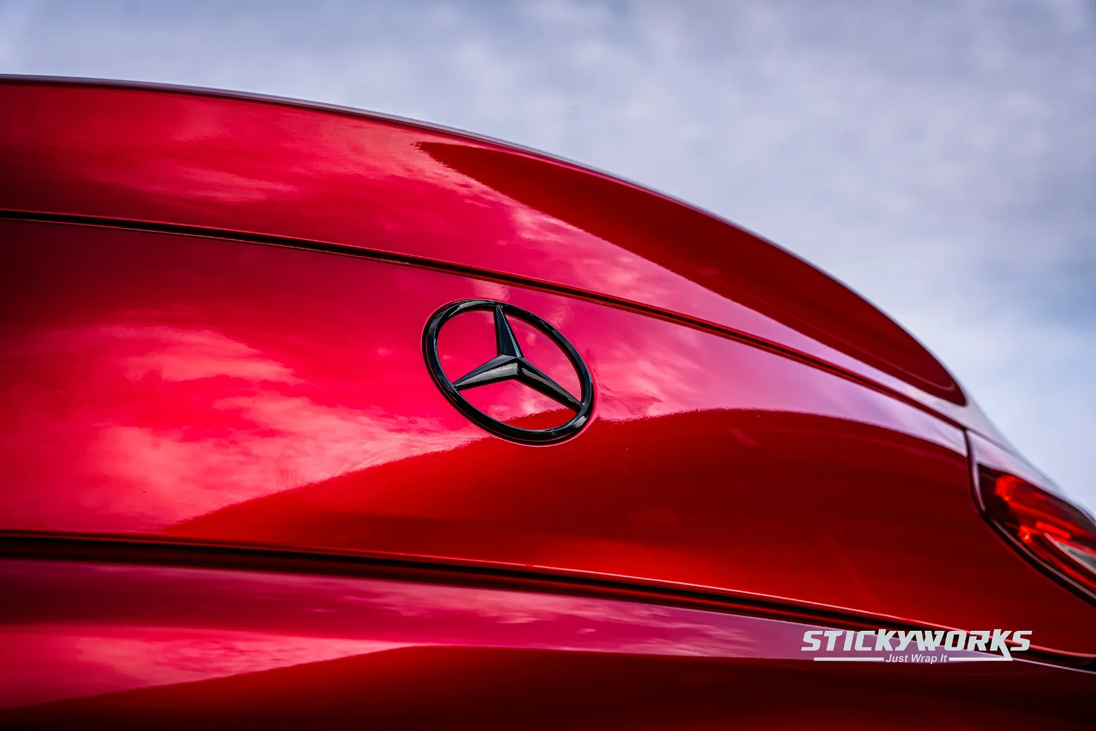StickyWorks Mercedes rear badge detail with gloss red wrap showing high-quality finish and reflections