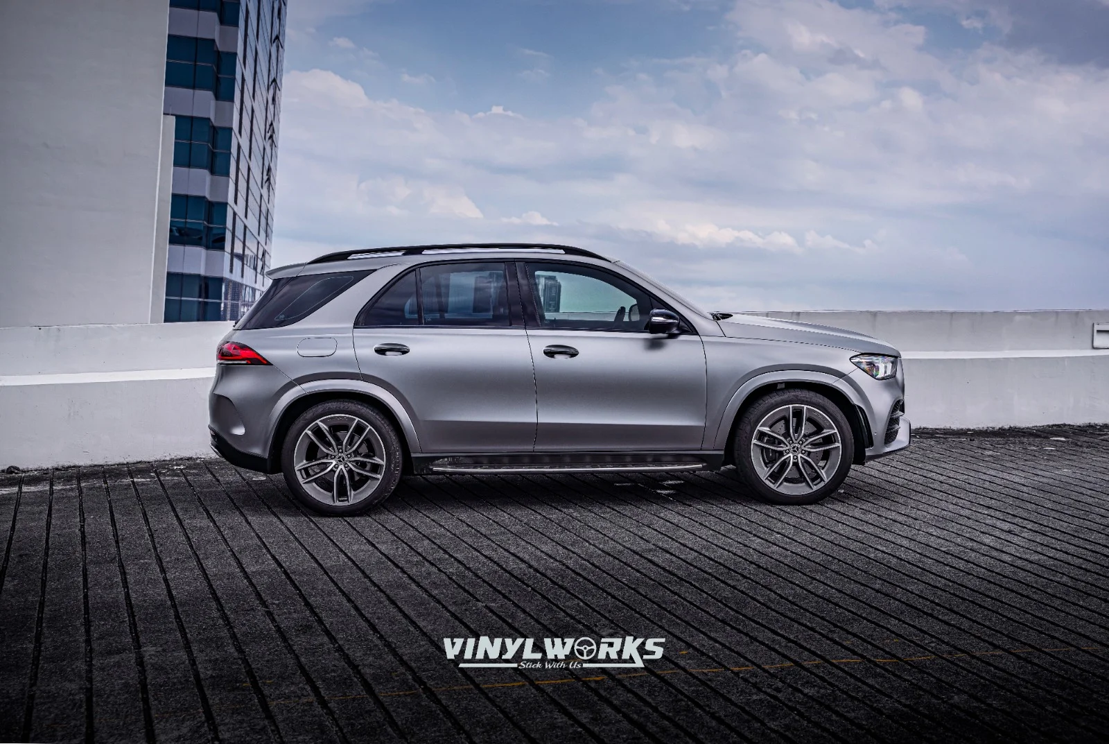 StickyWorks Mercedes SUV satin grey wrap side profile showcasing smooth vinyl finish and premium installation