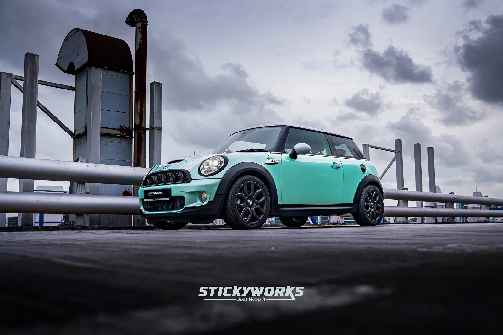 StickyWorks Mini Cooper mint car wrap parked on rooftop with full vehicle angle view and premium finish