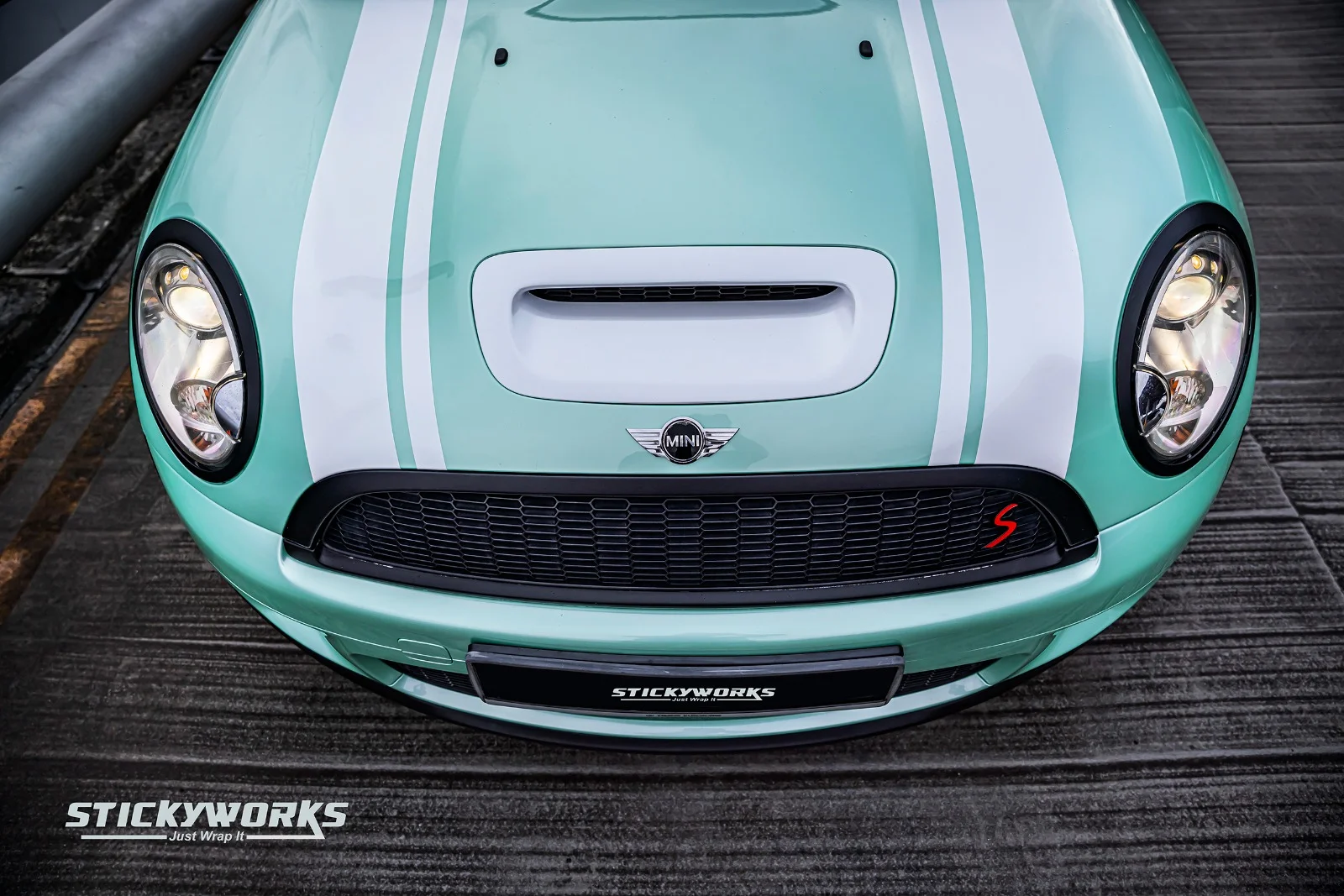 StickyWorks Mini Cooper front close-up with mint wrap and white racing stripes showcasing precision vinyl installation