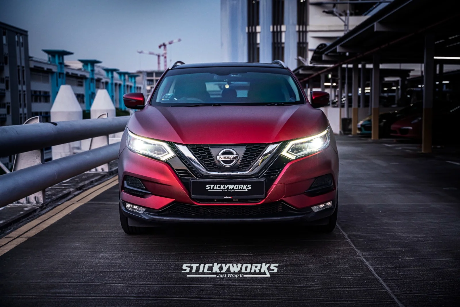 StickyWorks Nissan Qashqai front view showcasing bold red wrap with clean edges and professional finish