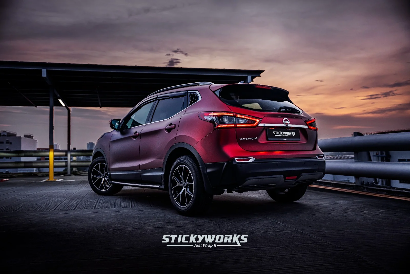 StickyWorks Nissan Qashqai rear angle view with red vinyl wrap emphasizing seamless installation and detailing
