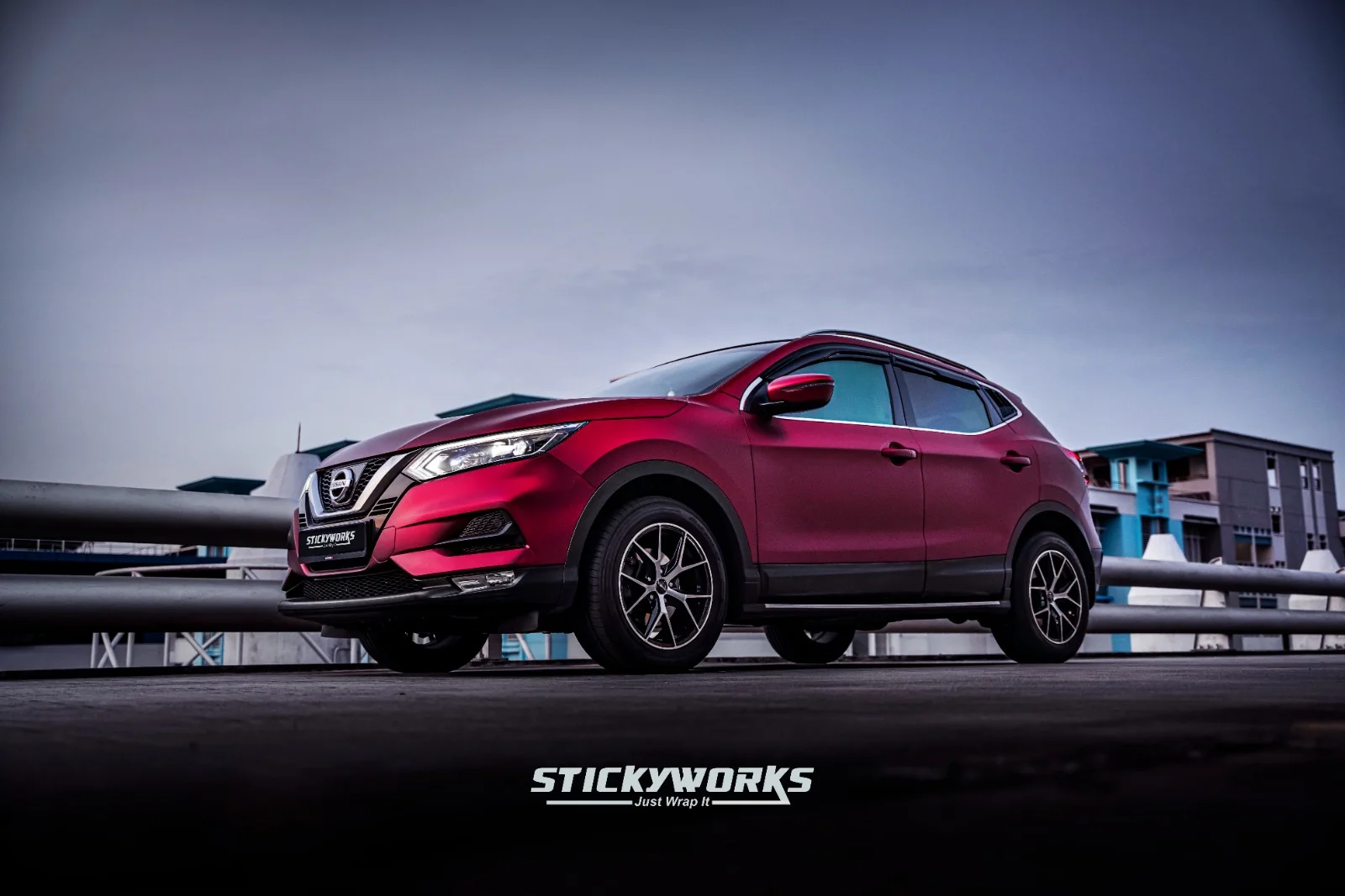 StickyWorks Nissan Qashqai side angle with red wrap highlighting full body coverage and sleek styling