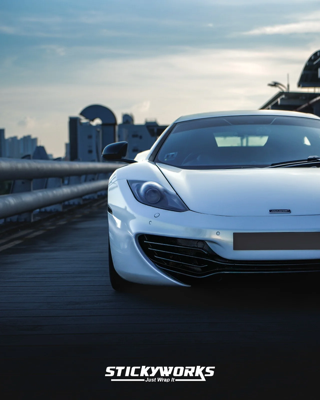 StickyWorks white supercar front angle shot showcasing clean vinyl wrap finish and premium detailing in low light
