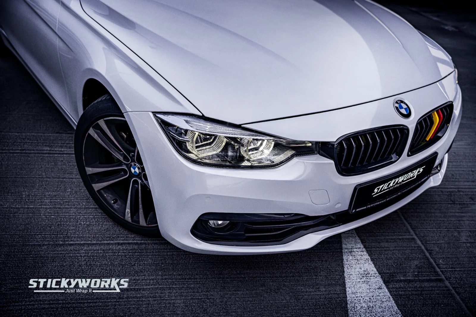 White BMW 3 Series front angle with custom wrap finish and enhanced gloss by StickyWorks Singapore