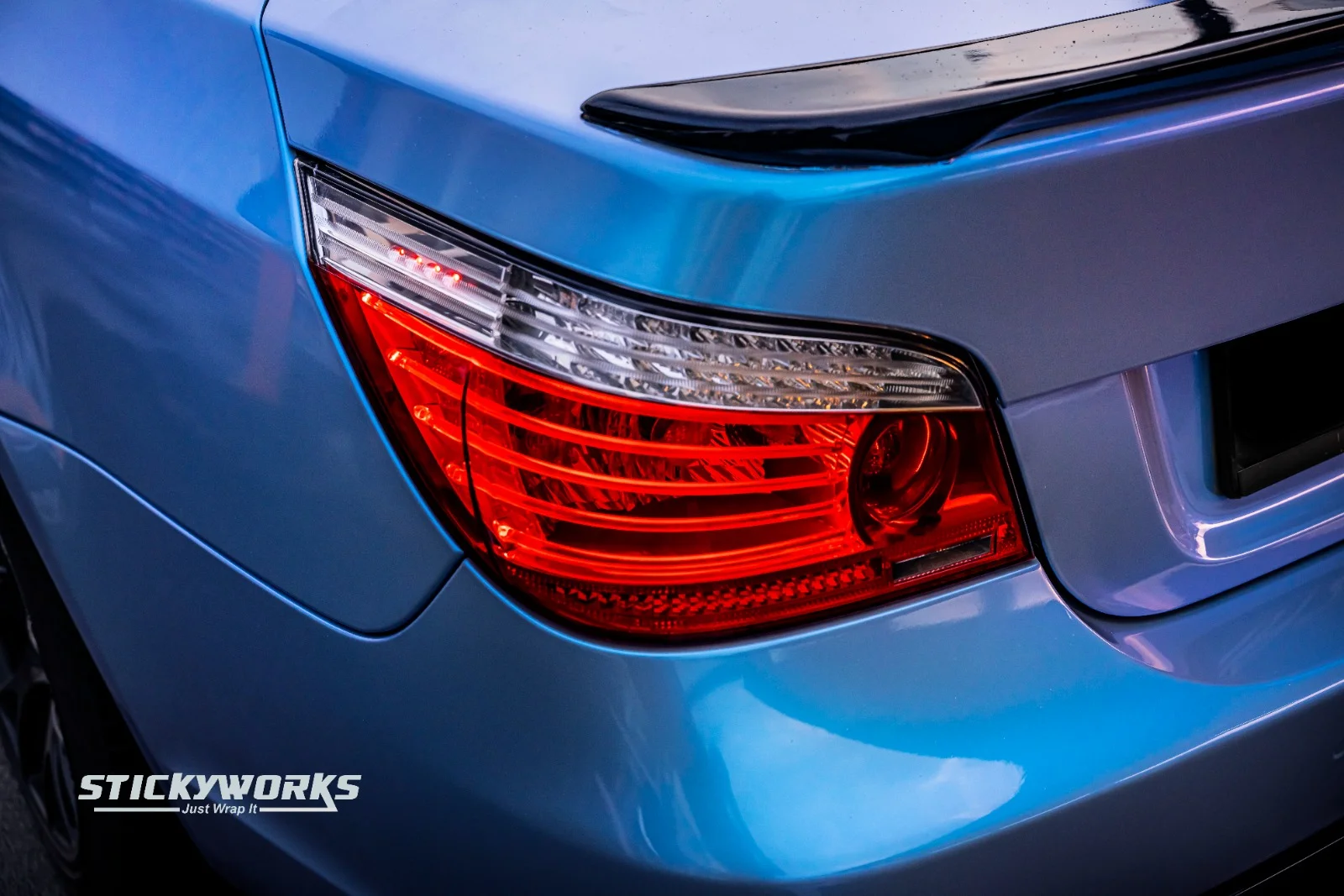 Close-up of BMW headlight and front grille with custom wrap and lighting accents