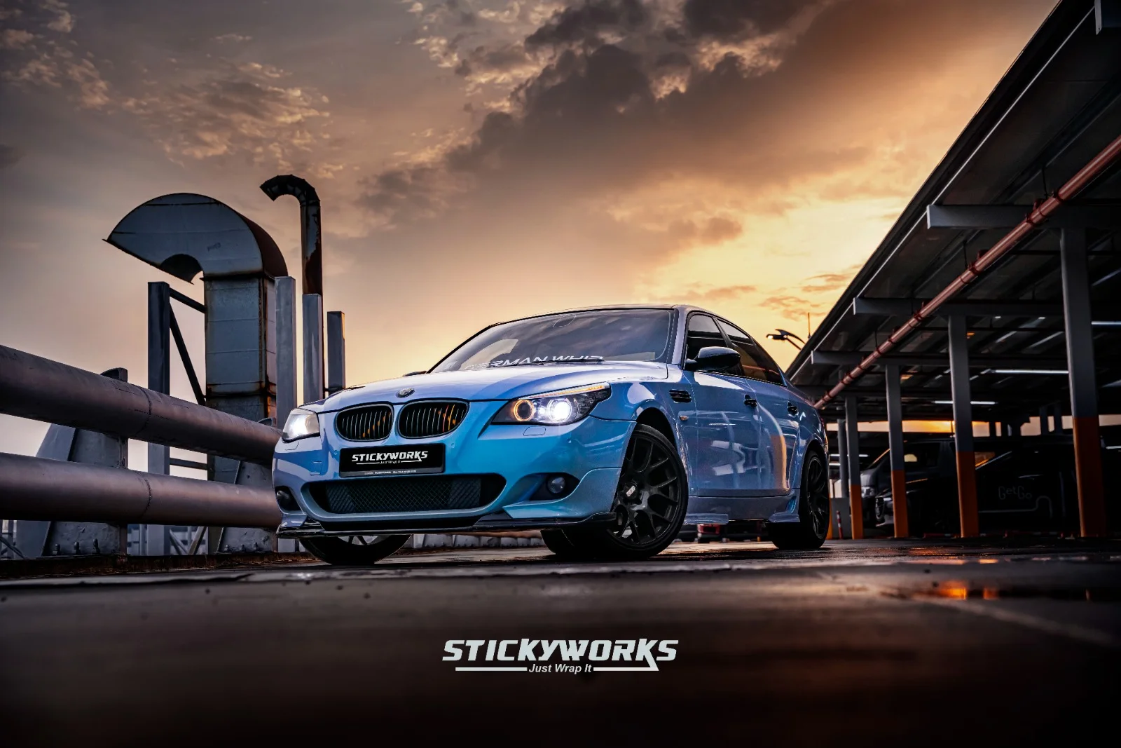 StickyWorks BMW blue wrap front angle showing sporty finish and aggressive styling on performance sedan