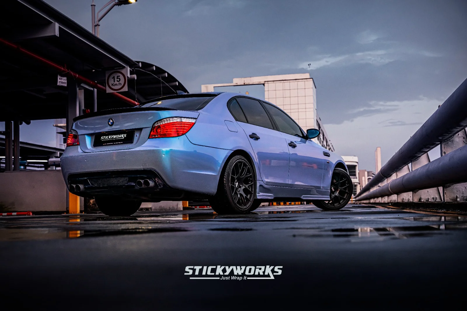 StickyWorks BMW rear angle in blue wrap emphasizing sporty stance and clean wrap execution