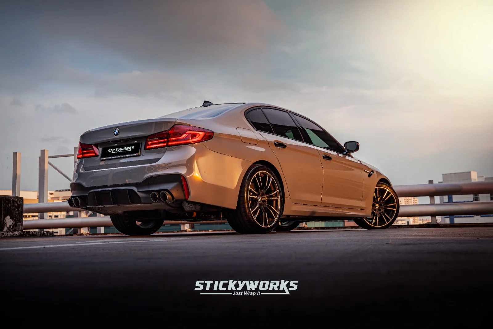 StickyWorks BMW rear angle in silver wrap during sunset highlighting smooth finish and premium styling