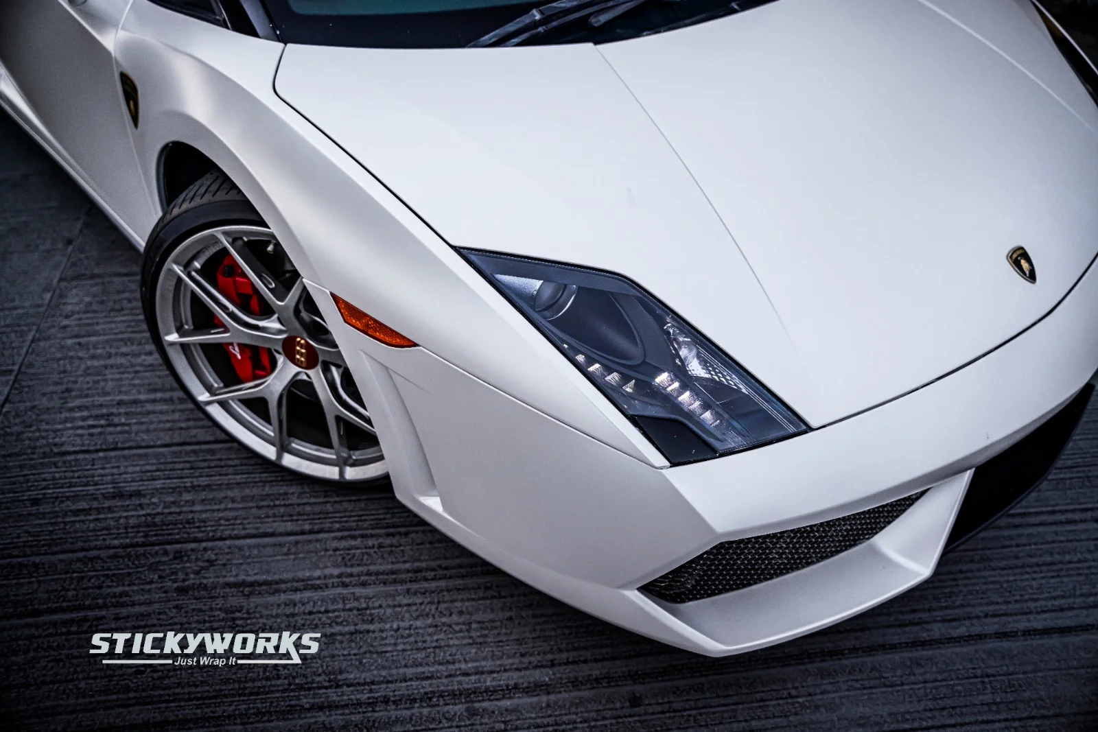 StickyWorks Lamborghini front detail in matte white wrap showcasing sharp lines and smooth satin finish